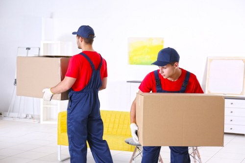 Removal team loading boxes outside a Forest Gate terraced house