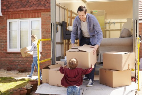 Packed boxes and furniture ready for a house move in Forest Gate