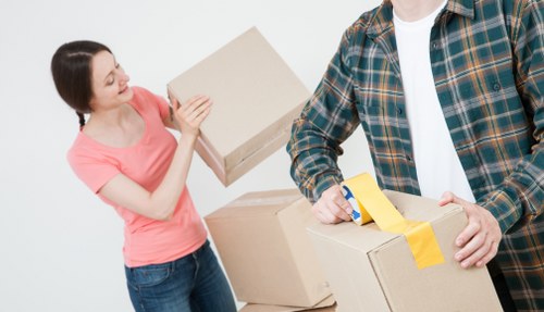 Movers navigating stairs and access challenges in a Forest Gate flat move