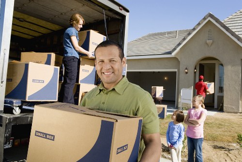 Professional movers transporting office equipment for a Forest Gate business